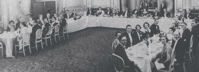 An image of a group of people sat down to dinner at a large dining table.